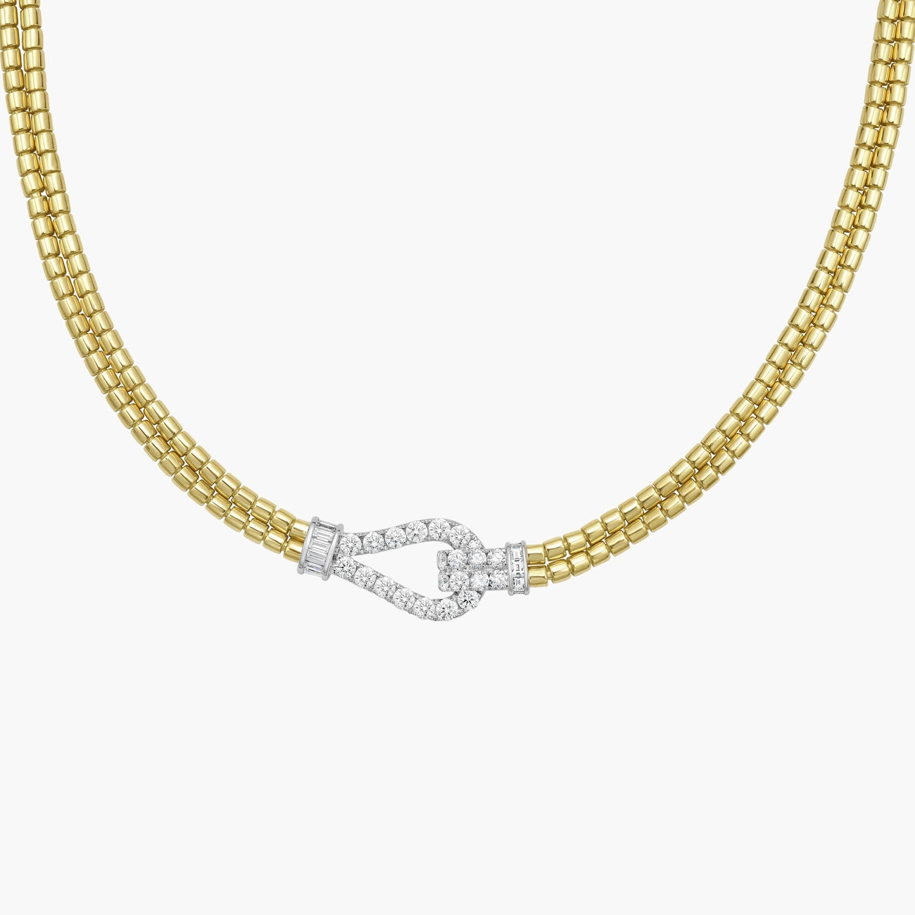 A gold multi-strand chain necklace with a bow-shaped clasp paved with small clear stones, shown on a plain white background.