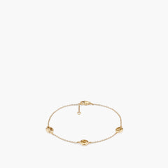 Gucci Interlocking Station Bracelet in yellow gold featuring three interlocking G logo stations spaced along a delicate chain with lobster clasp closure
