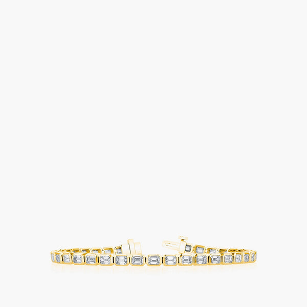 East-west emerald diamond tennis bracelet in 18K yellow gold with 7.4ct diamonds, top view