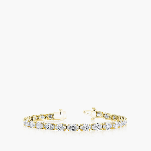 East-west oval-cut diamond tennis bracelet in 18K yellow gold, front view