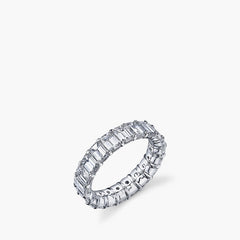 Larger emerald-cut diamond eternity band in platinum showing 360-degree setting, top view