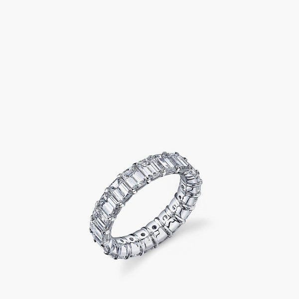 Larger emerald-cut diamond eternity band in platinum showing 360-degree setting, top view